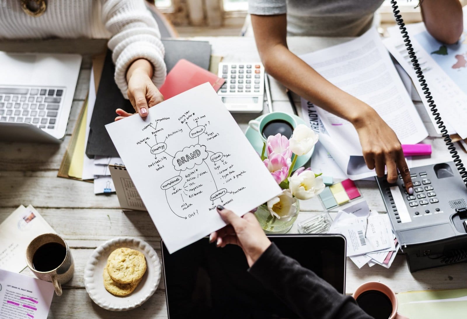 colleagues-handing-branding-plan-strategy-to-othe